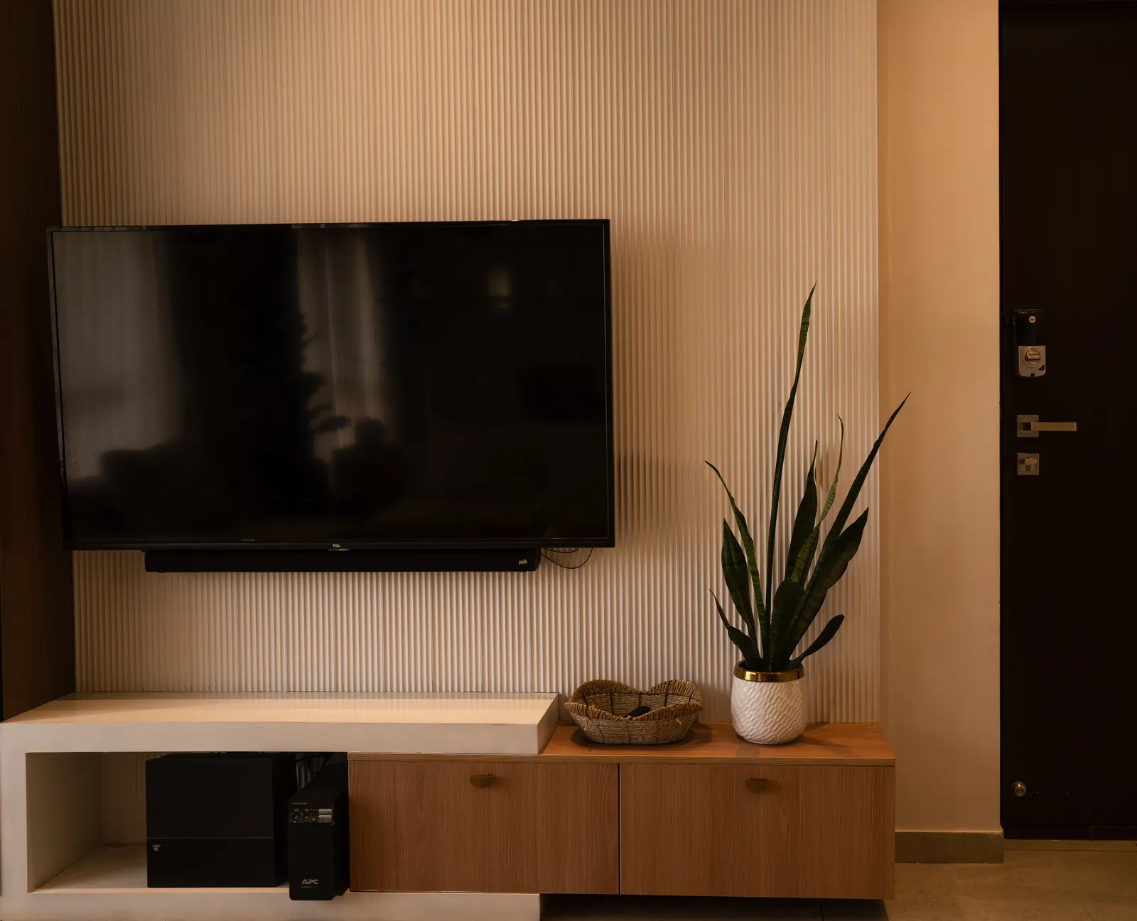 White fluted TV wall with oak and white console — Amlan's Residence